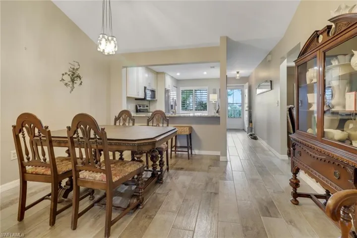 Dining space with light hardwood / wood-style flooring and a notable chandelier