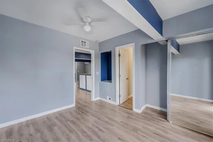 Unfurnished bedroom with ceiling fan and light hardwood / wood-style flooring