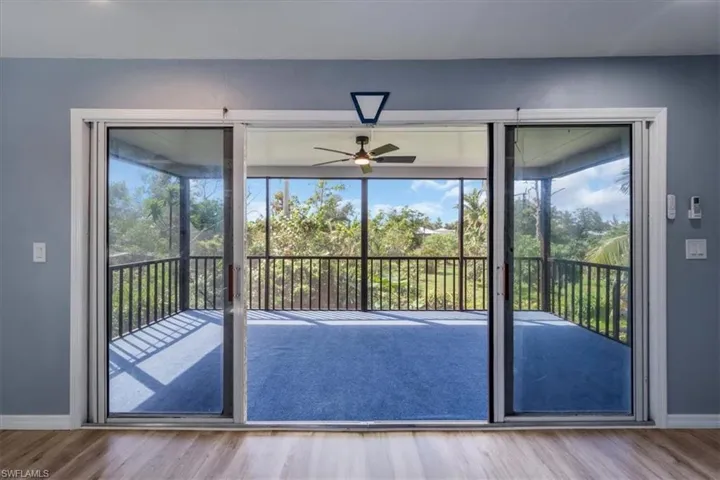 Entryway with ceiling fan, plenty of natural light, and wood-type flooring