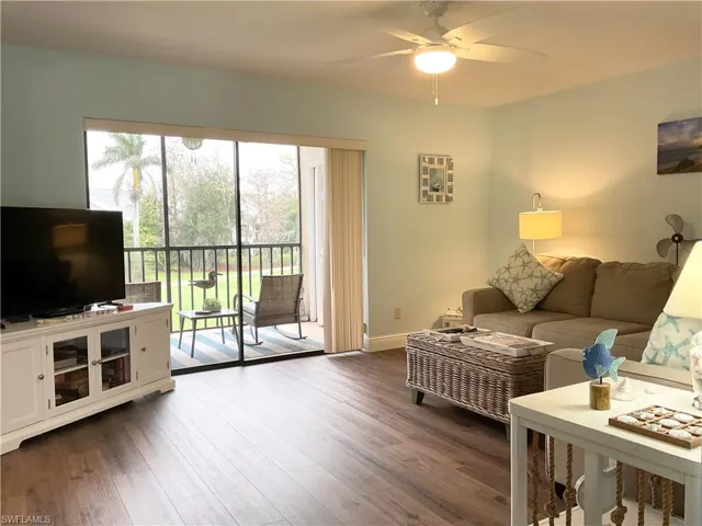 Living room with vinyl wood-style flooring and ceiling fan