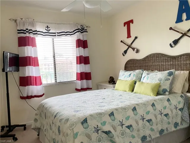 Guest Bedroom with ceiling fan and carpet
