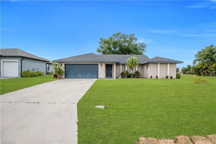 Single-story residence featuring a gray garage door, a concrete driveway, and a shingle roof