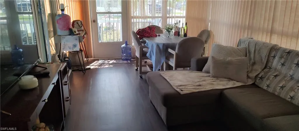 Living room featuring dark wood-style floors