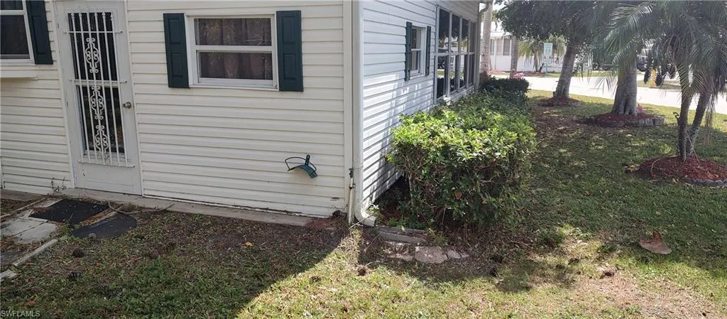 View of side of property with a yard