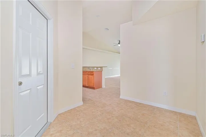 Unit #613 Vacant Corridor featuring lofted ceiling and light tile patterned flooring