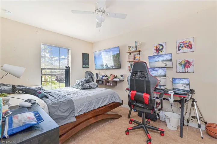 Bedroom with tile patterned floors and a ceiling fan