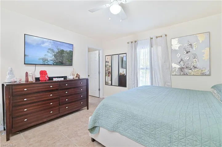 Bedroom featuring a ceiling fan and light tile patterned floors