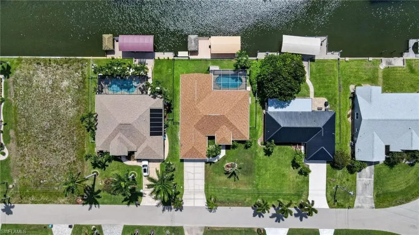 Aerial property overview featuring a canal-front location