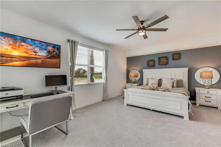 Carpeted bedroom with ceiling fan