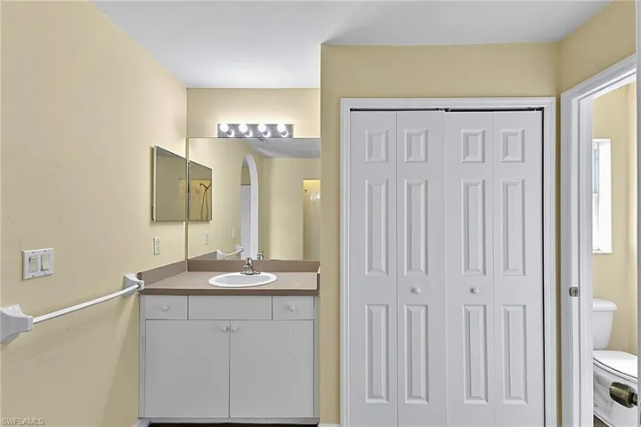 Bathroom vanity featuring a single sink, integrated countertop, and lower cabinetry