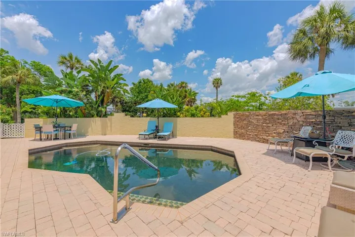 View of swimming pool featuring a patio area with new privacy wall
