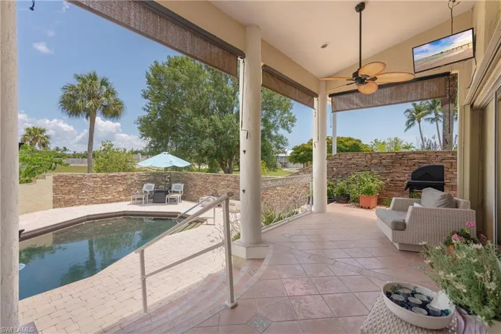 View of swimming pool featuring ceiling fan and a patio area