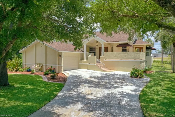 View of front facade featuring a garage and a spacious front yard