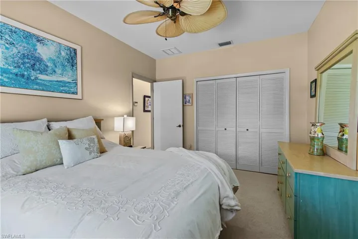 Bedroom 2 featuring a closet, ceiling fan, and carpet floors
