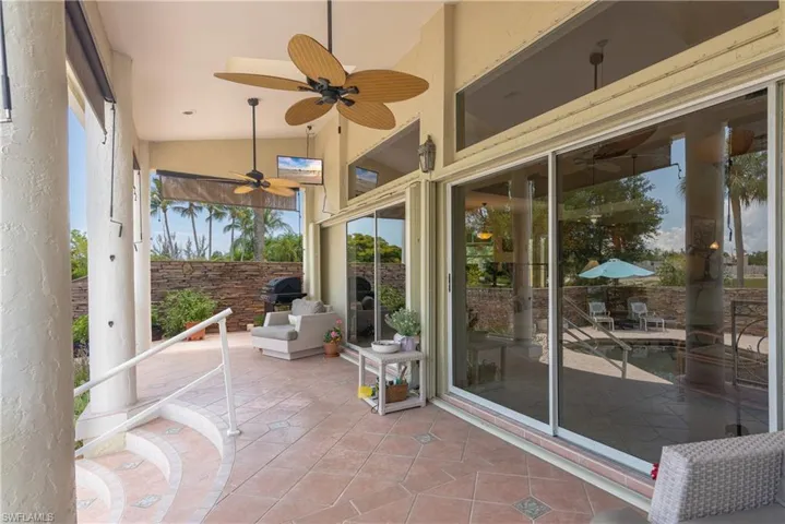 View of terrace featuring ceiling fans
