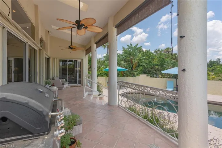 View of patio featuring area for grilling and ceiling fan