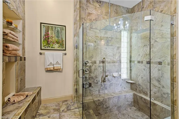 Main Bathroom featuring walk in shower and tile floors