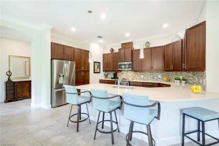 Kitchen features pendant lighting, stainless appliances, quartz countertops & so much more!