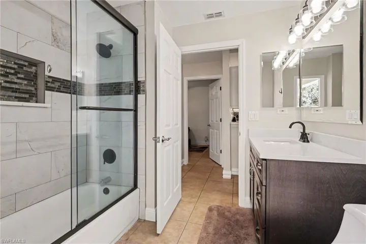 The guest bathroom (also your cabana bath). Remodeled with more exquisite Quartz counters & glass tile inlay