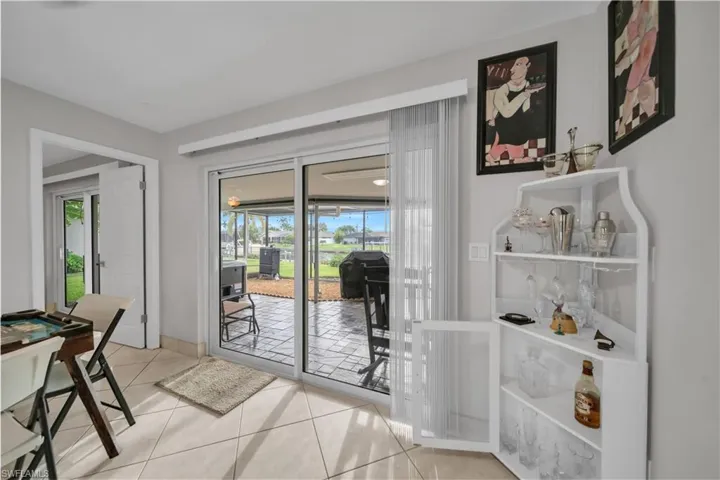 Entryway with tile patterned floors and a sunroom