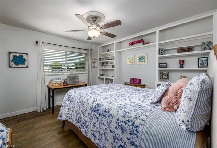 Bedroom with ceiling fan and dark hardwood / wood-style floors