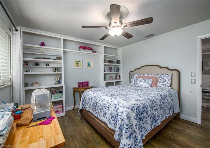 Bedroom featuring ceiling fan and dark hardwood / wood-style floors