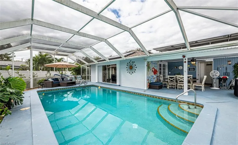 View of pool featuring a lanai, a patio area, ceiling fan, and outdoor lounge area