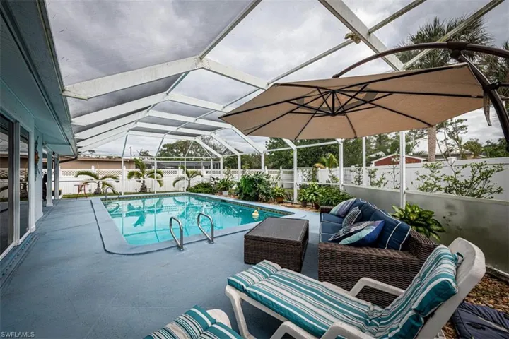 View of swimming pool featuring a lanai and a patio