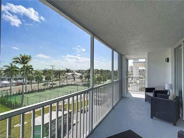 Balcony featuring a sunroom
