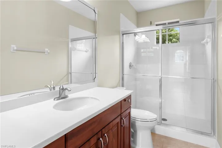 Ensuite Bath to Guest room 1. Vanity, mirrors and walk in shower.