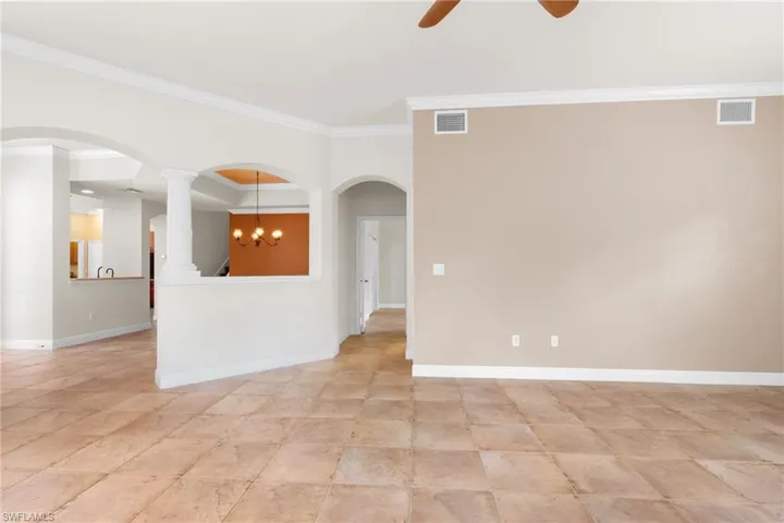 Spacious living room looking to hall 1/2 bath and Primary Bedroom.