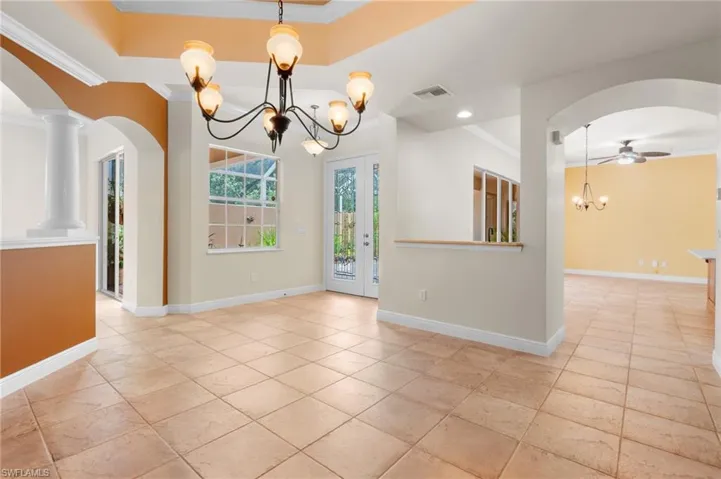 Dining area looking toward foyer and kitchen.