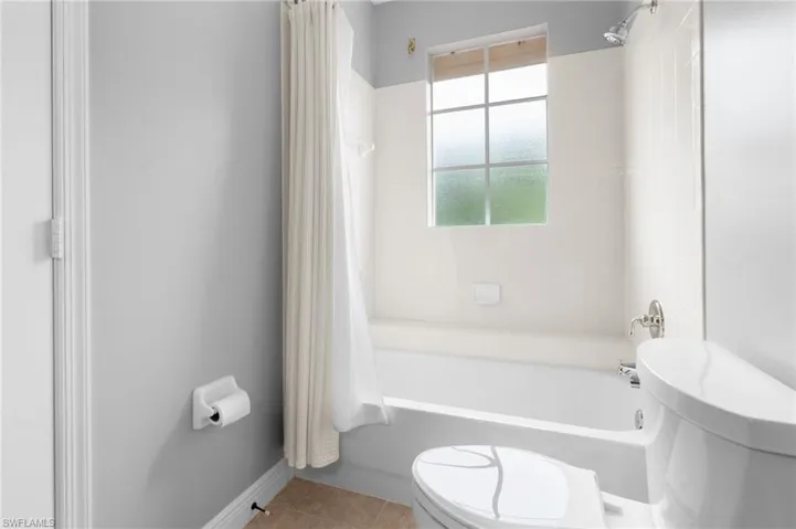 Guest Bathroom 2 featuring tile floors, toilet, and shower / bath combo.