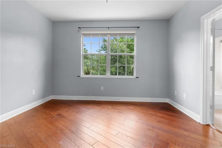 Guest Bedroom 2 featuring wood flooring with ensuite bath.