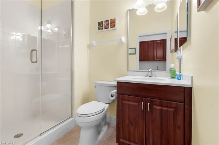 Cabana full bath with walk in shower, vanity, lighting, tile.