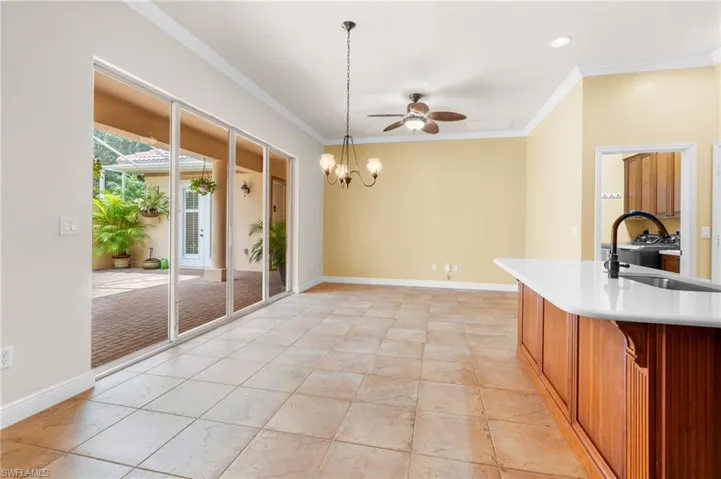 Family style kitchen area with wet bar, island, casual dining and family room.