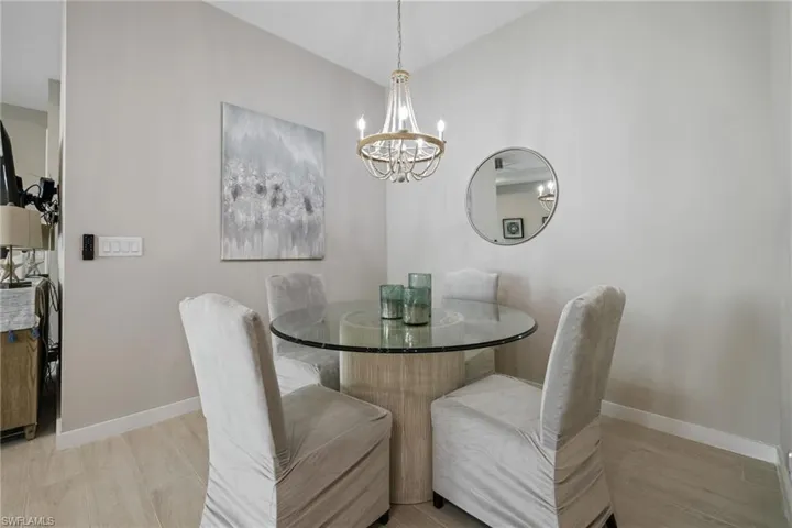 Dining area with a notable chandelier and baseboards