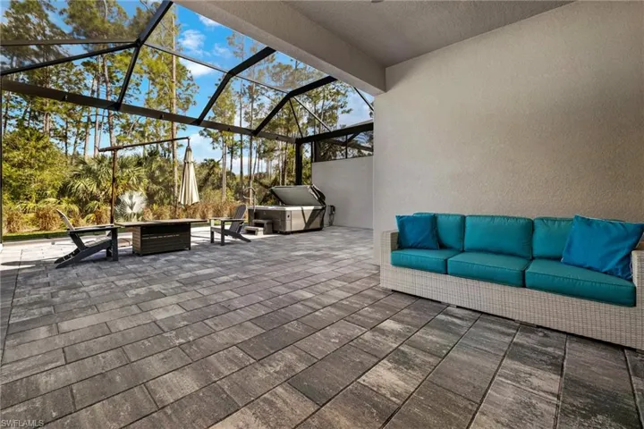 View of patio / terrace with an outdoor living space with a fire pit and a lanai