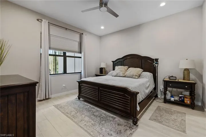 Bedroom featuring ceiling fan, baseboards, and recessed lighting