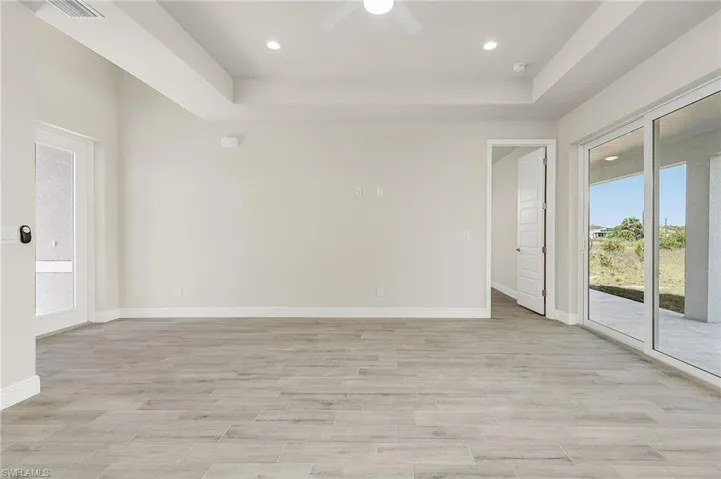 Spare room with ceiling fan and a raised ceiling
