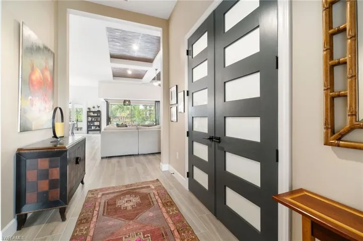 Stunning front entrance with double doors to the den, enhanced by upgraded glass inserts