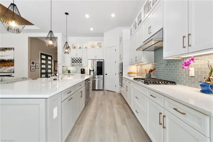 The kitchen is a chef's dream, featuring elegant glass-doored upper cabinets