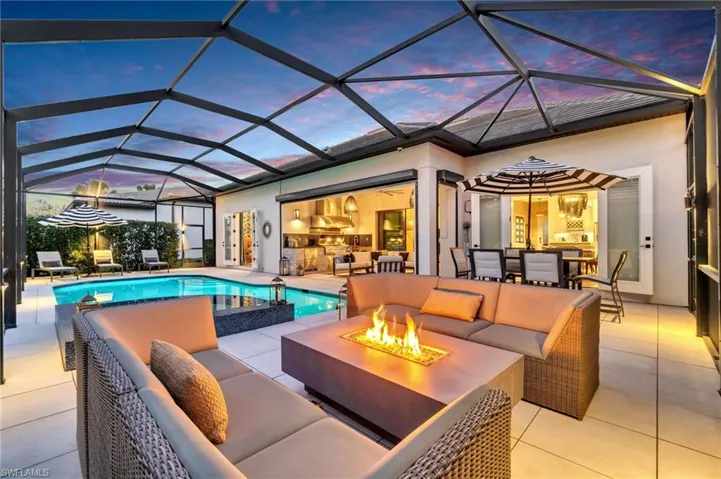 A cozy atmosphere awaits by the firepit, just off the pool, as the sun sets and the evening breeze settles in