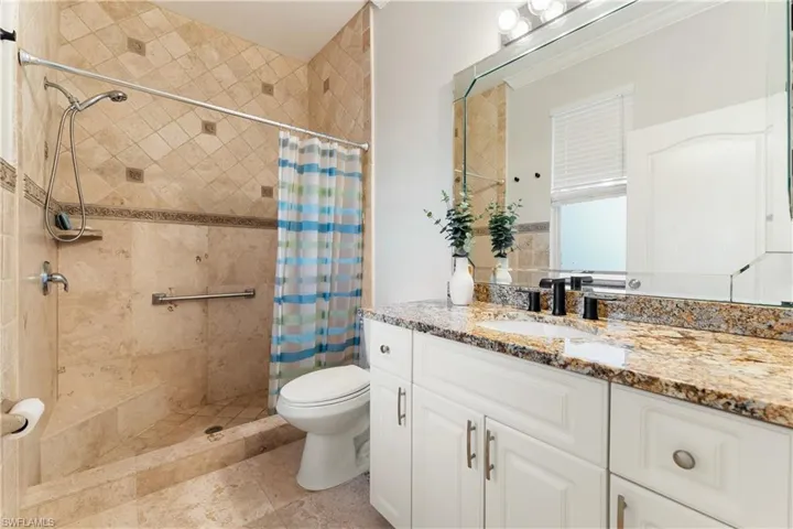Full bath featuring vanity and a stall shower