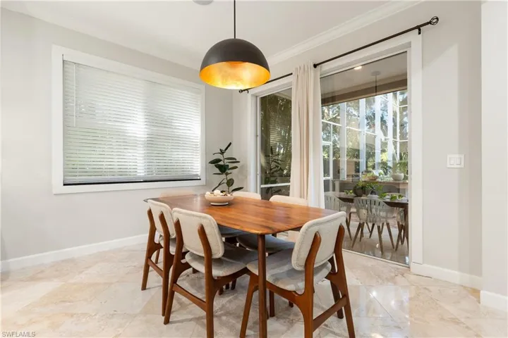Dining room with baseboards and crown molding