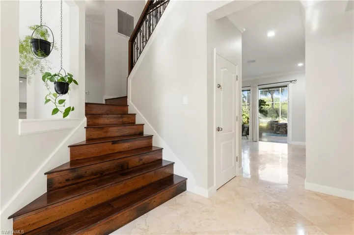 Stairs featuring crown molding and recessed lighting