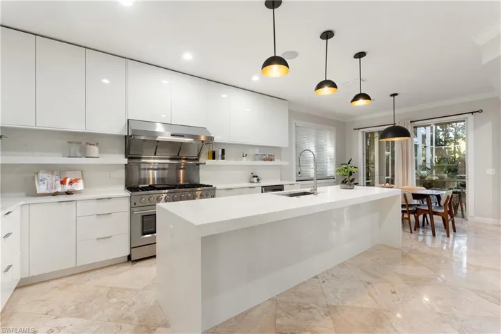 Kitchen with modern cabinets, open shelves, white cabinets, ornamental molding, and recessed lighting