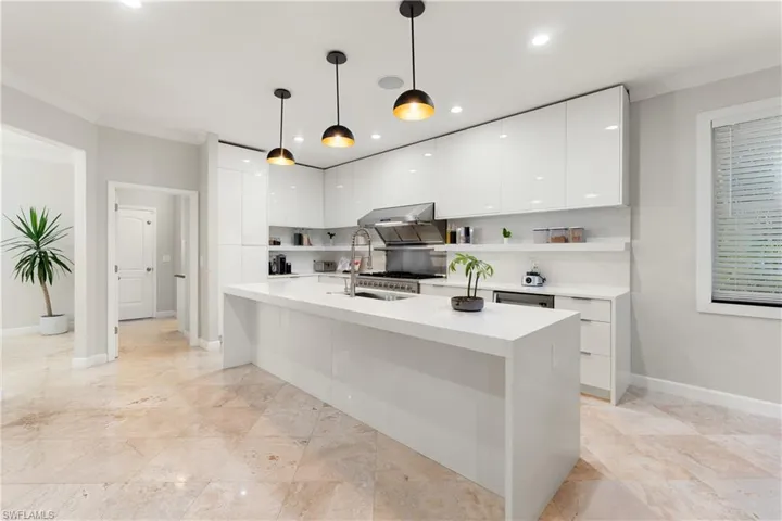 Kitchen featuring white cabinets, modern cabinets, crown molding, pendant lighting, and open shelves