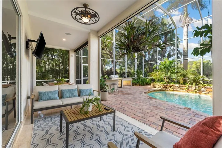 Sunroom / solarium with a pool and recessed lighting