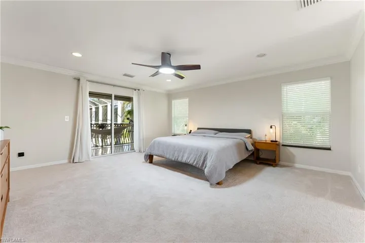 Bedroom with ornamental molding, light carpet, access to outside, a ceiling fan, and recessed lighting